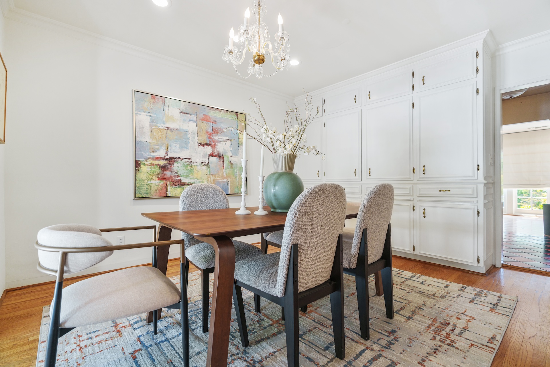 Dining room with crystal chandelier and cabinetry
